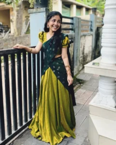 Model wearing green dhavani dress in designer boutique calicut