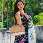 Model wearing black printed saree in designer boutique calicut