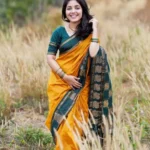 Model wearing orange color saree in designer boutique calicut