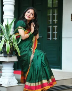 Model wearing dark green color saree in designer boutique calicut