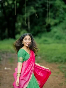 Model wearing pink & green color dhavani in designer boutique calicut