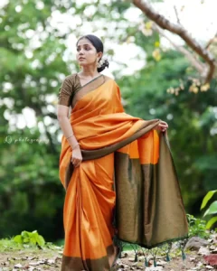 Model wearing orange color saree in designer boutique calicut