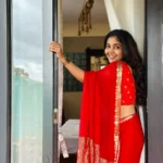 Model wearing red color saree in designer boutique calicut