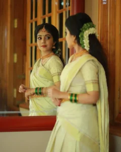 Model wearing traditional set saree in designer boutique calicut